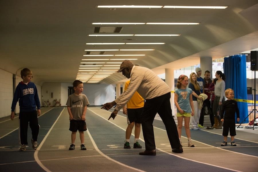 Coach James Barber instructing children in age group track.