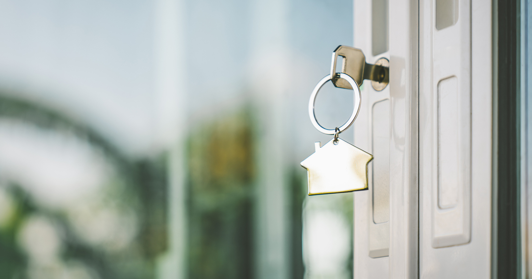 House model and key in home with light from window. Real estate agent offer house, property insurance and security, affordable housing concepts