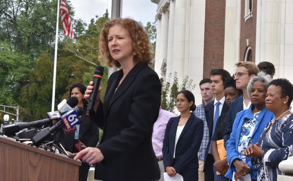 Erin Boggs speaks in Woodbridge with the Open Communities Alliance. Courtesy: New Haven Independent.